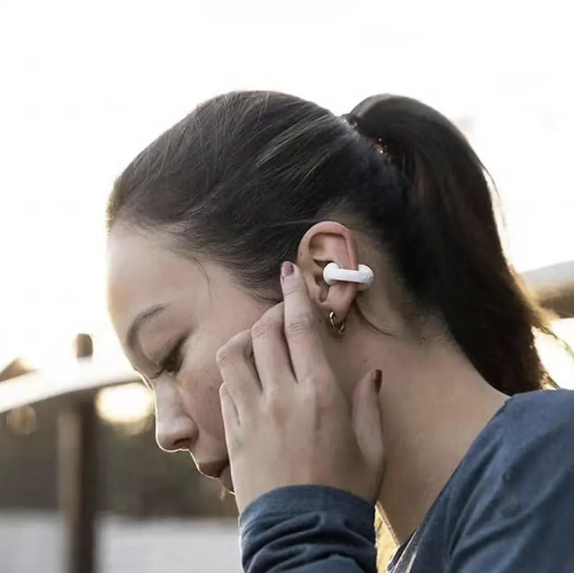 Ambie bone conduction headphones worn by a lady Ambie bone conduction headphones worn by a lady